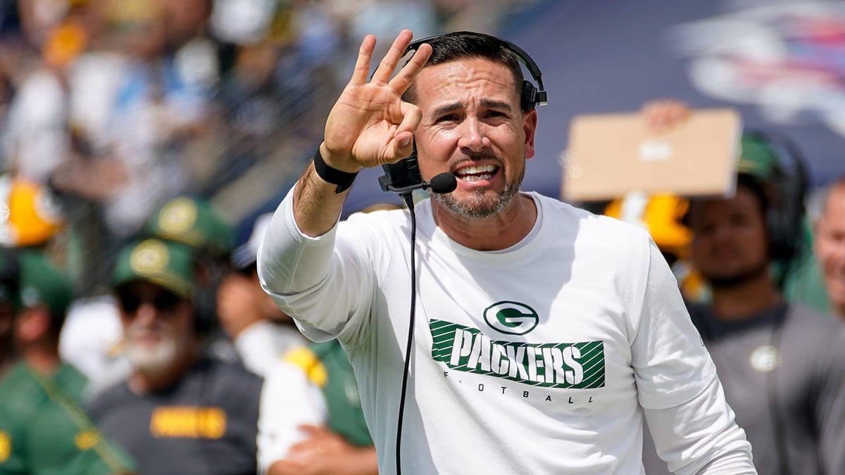 Matt LaFleur motions on field