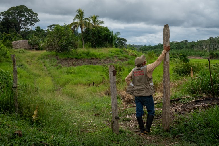 Fredy Capitan, an Indigenous protection agent for Peru’s government, surveys a village where isolated tribes are making increased contact [Neil Giardino/Al Jazeera]