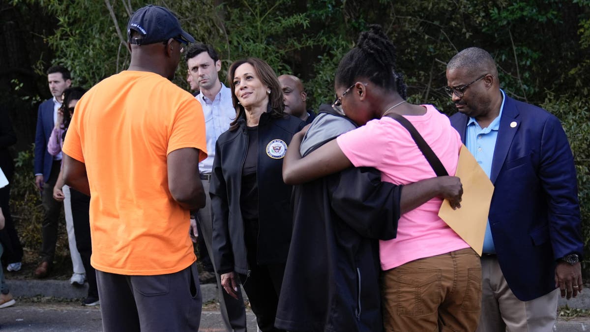 Democratic presidential nominee Vice President Kamala Harris greets people who were impacted by Hurricane Helene in Augusta, Ga., Wednesday, Oct. 2, 2024, as Augusta Mayor Garnett Johnson watches at right.