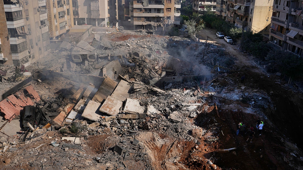 People gather near the site of the assassination of Hezbollah leader Hassan Nasrallah in Beirut's southern suburbs