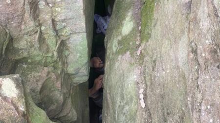 Woman becomes stuck upside down between boulders for 7 hours while trying to retrieve dropped phone