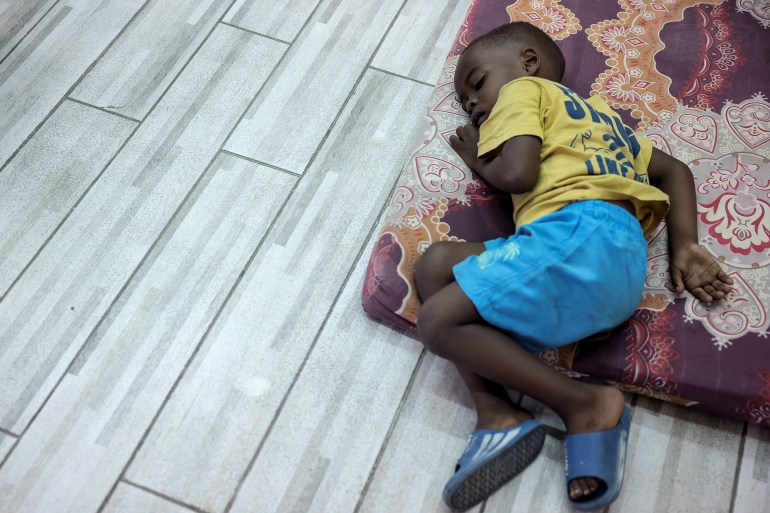 A child sleeps in the temporary shelter for migrants at St. Joseph Church in Beirut