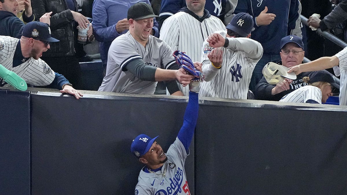 Fans pull ball out of Mookie Betts glove