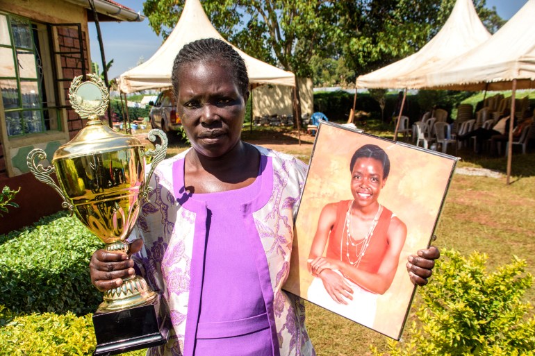 Tirop's mom holds her portrait and cup