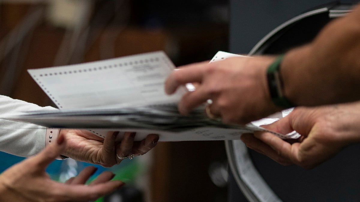 poll workers handling ballots