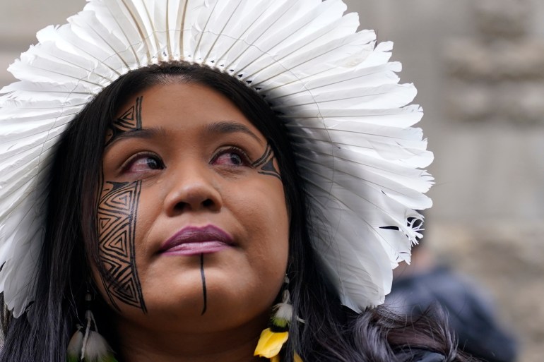 Wakrewa Krenak, from Brazil, stands outside the Royal Courts of Justice in London, Monday, Oct. 21, 2024, as lawyers representing around 620,000 Brazilians as well as businesses, municipal governments, and members of the Krenak indigenous tribe are bringing a multibillion-pound legal action against BHP Group following the collapse of the Fundao dam in November 2015.