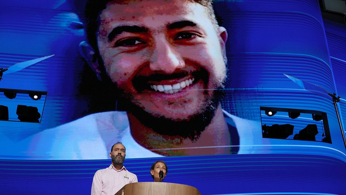 Jon Polin and Rachel Goldberg, parents of Hersh Goldberg-Polin, pictured on screen, speak during the Democratic National Convention