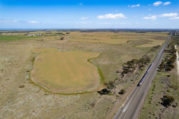 A train travels past the possible site for a freight terminal proposed by Pacific National in Little River.