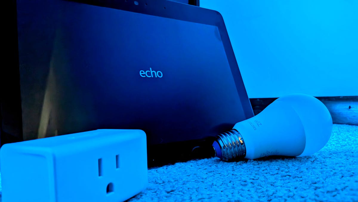 Amazon Echo 10 (2nd Gen), smart light, and smart plug bathed in a  blue light.