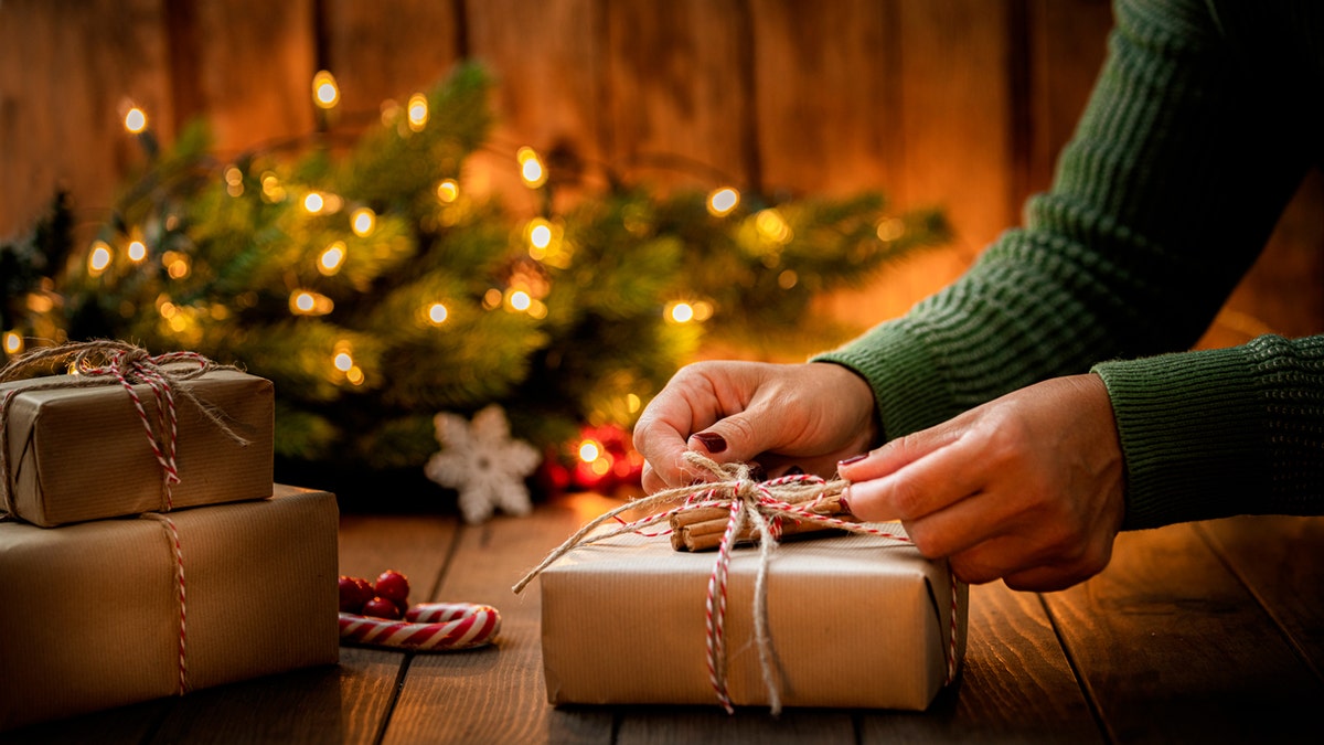 Person putting final touches on Christmas gift