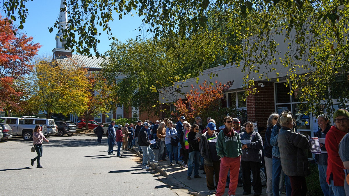 A large line of potential voters wait outside an early voting site on Oct. 17, 2024 in Asheville, North Carolina.  