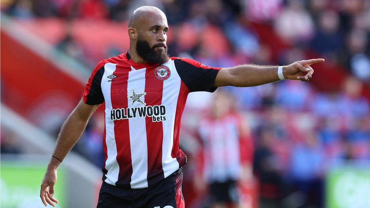 Brentford striker Bryan Mbeumo pointing with his left hand.