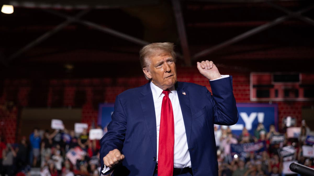 Donald Trump in blue coat, red tie dancing