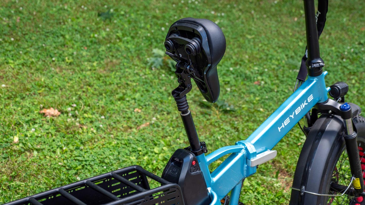 Heybike Mars 2.0 e-bike seat titled up on its seat post with grass in the background.