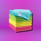 HOMEXCEL cleaning cloth on a pink purple gradient background