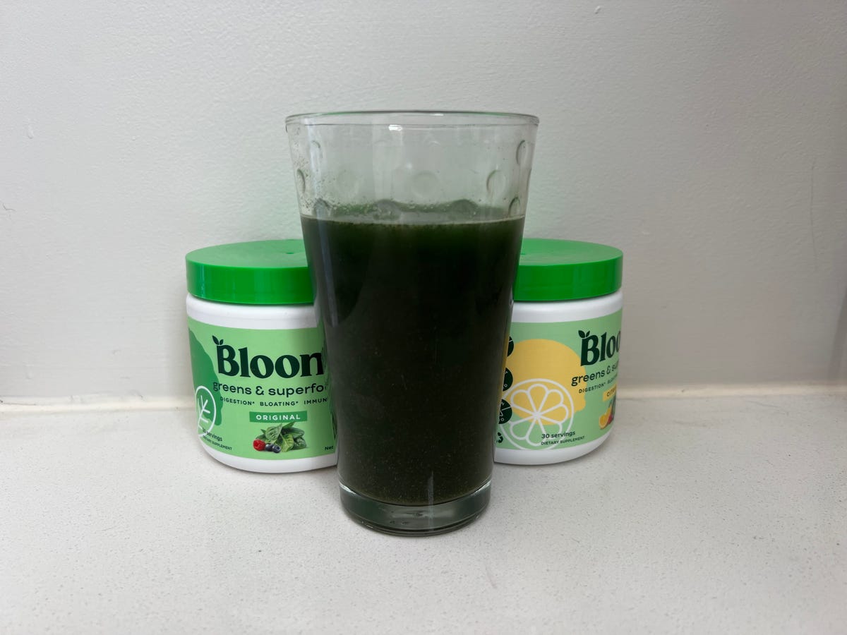 Glass of greens with two containers