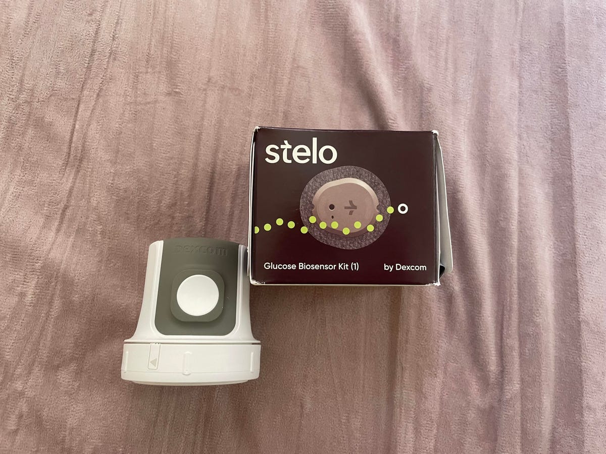 A Stelo sensor in a box next to an applicator