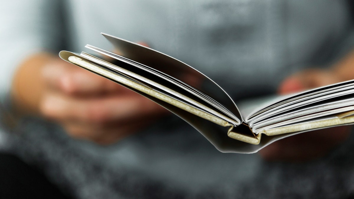 A close-up of a woman reading a book 