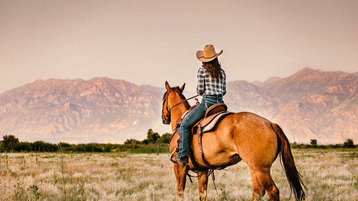 A woman riding a horse