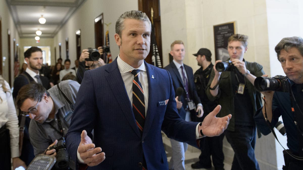 Pete Hegseth speaking with his hands up