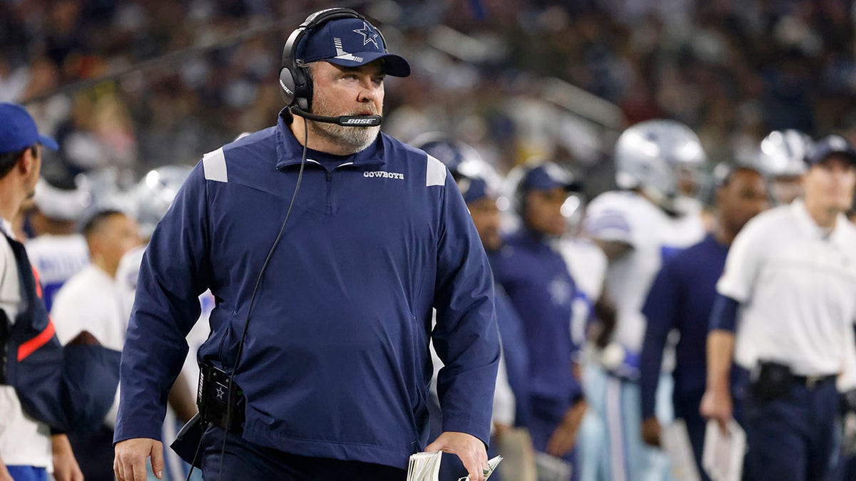 Mike McCarthy watches play during a game