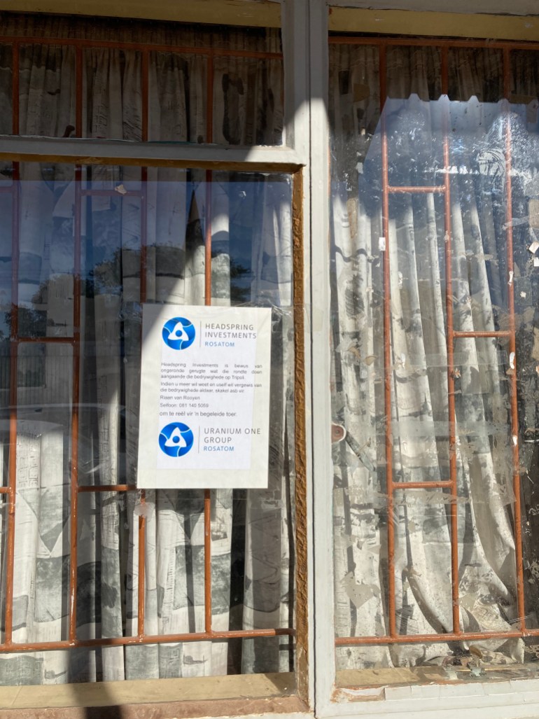 A shop window in Leonardville, Namibia, with a Rosatom poster pasted on its window [Tom Brown/Al Jazeera]