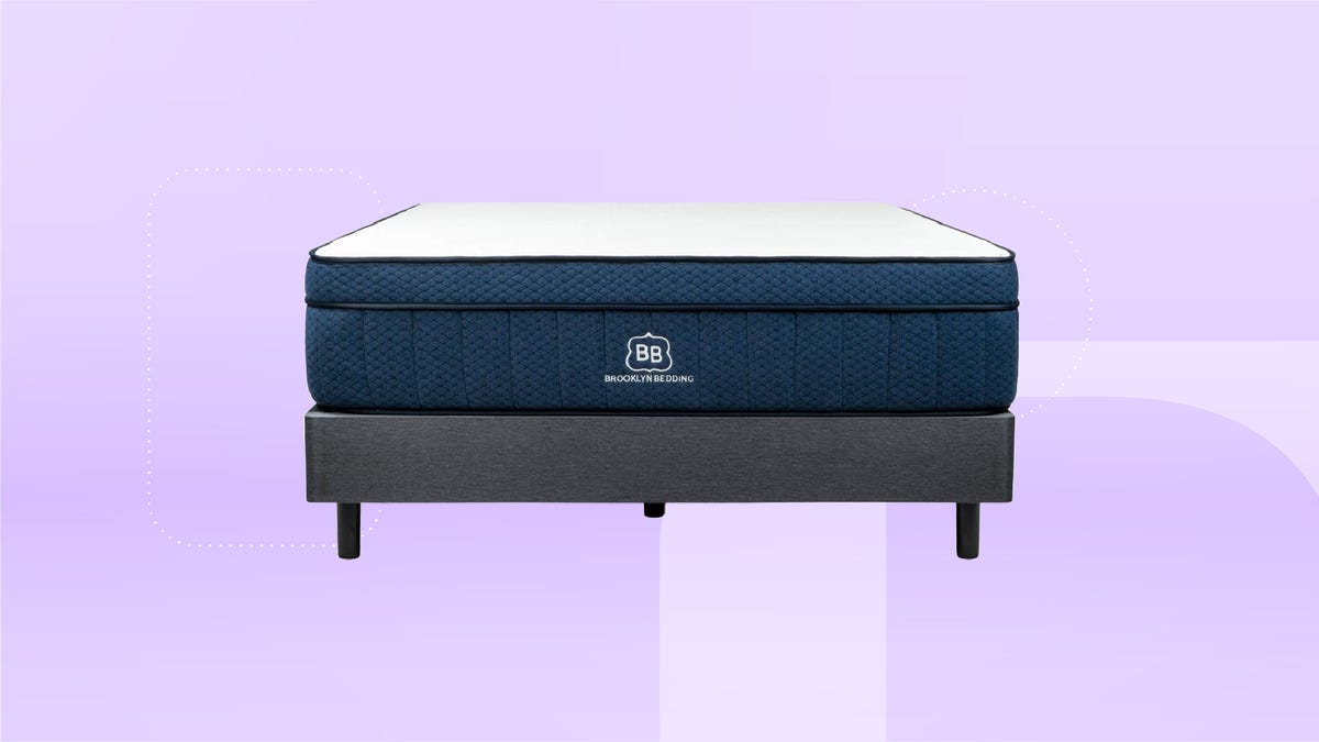 A blue and white Brooklyn Bedding mattress and grey bed frame against a purple gradient background. 