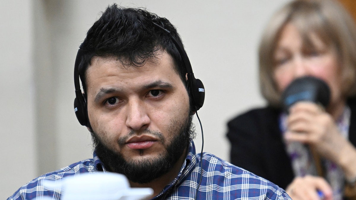 Jose Ibarra, accused of killing a Georgia nursing student earlier this year, listens through an interpreter during his trial