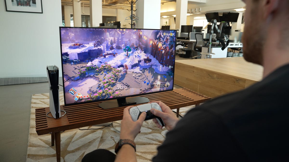 A monitor sitting on a coffee table displays gameplay.