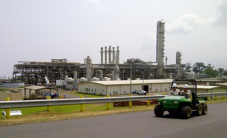 Employees drive past Africa's largest methanol plant at Punta Europa, in Equatorial Guineac [File: Pascal Fletcher/Reuters]