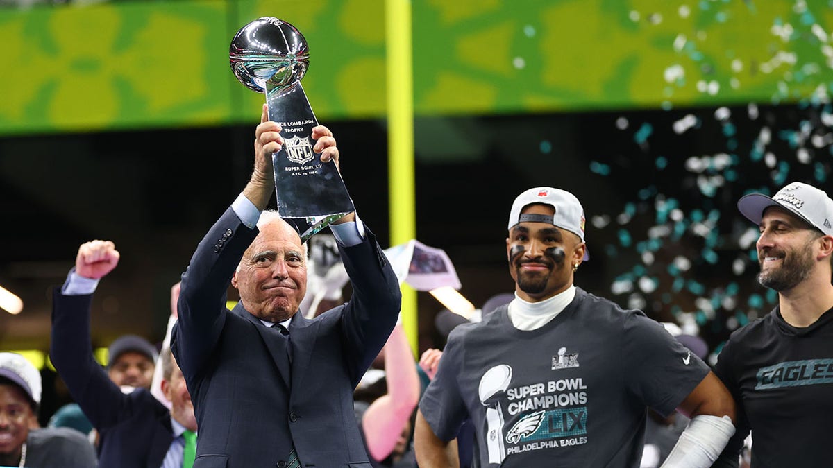 Jeffrey Lurie holds up Lombardi Trophy