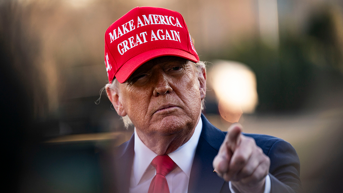 President Trump wearing a red MAGA hat