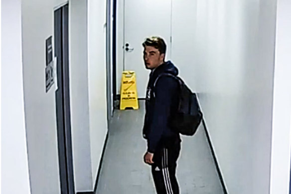 Still of CCTV vision showing Paul Thijssen outside the bathroom when Lilie James is inside.