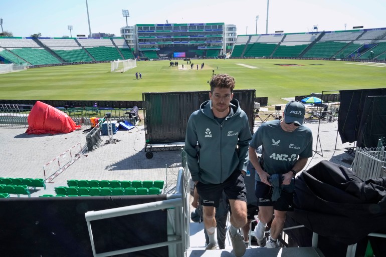 New Zealand's skipper Mitchel Santner, center, arrives for a press conference regarding their semifinal match against South Africa, in Lahore, Pakistan, Tuesday, March 4, 2025. (AP Photo/K.M Chaudary)