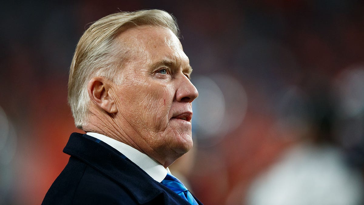 John Elway looks on field