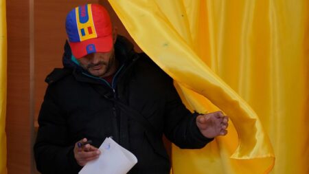 Romanians vote in cliffhanger election as tensions continue to rise