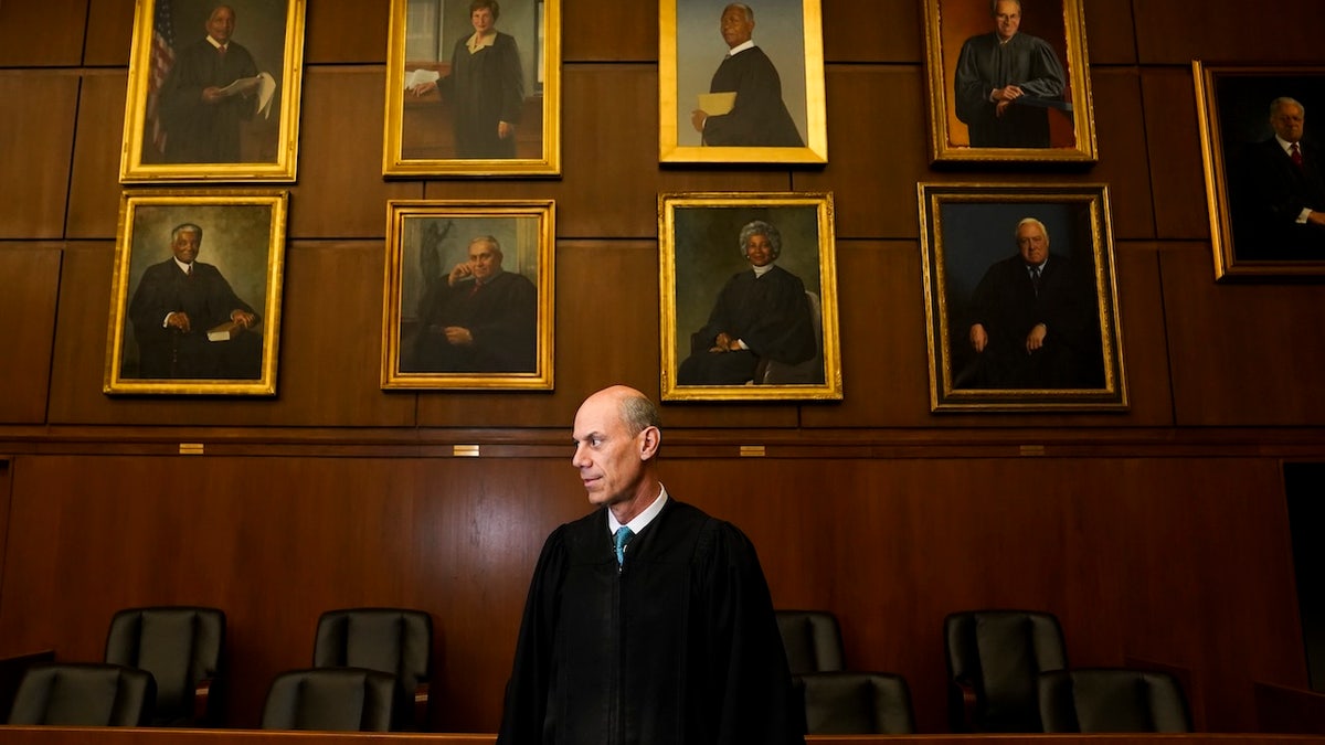 Boasberg in courthouse chamber with portraits