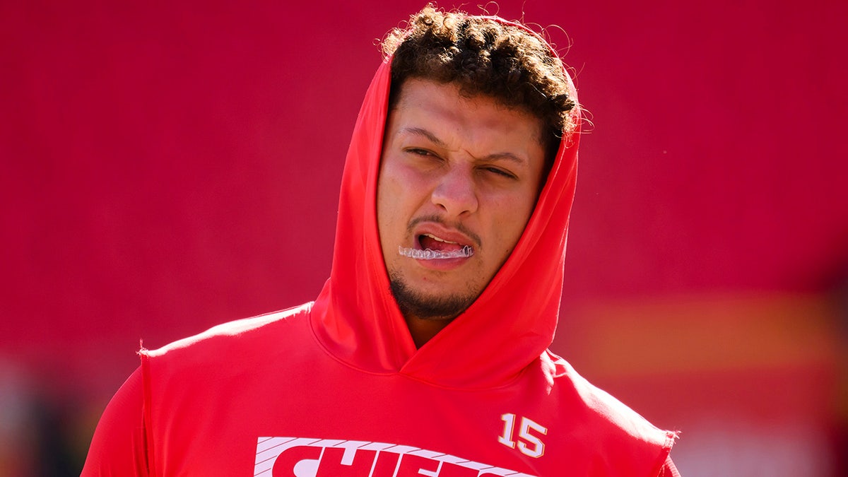 Patrick Mahomes wearing a red Chiefs sweatshirt