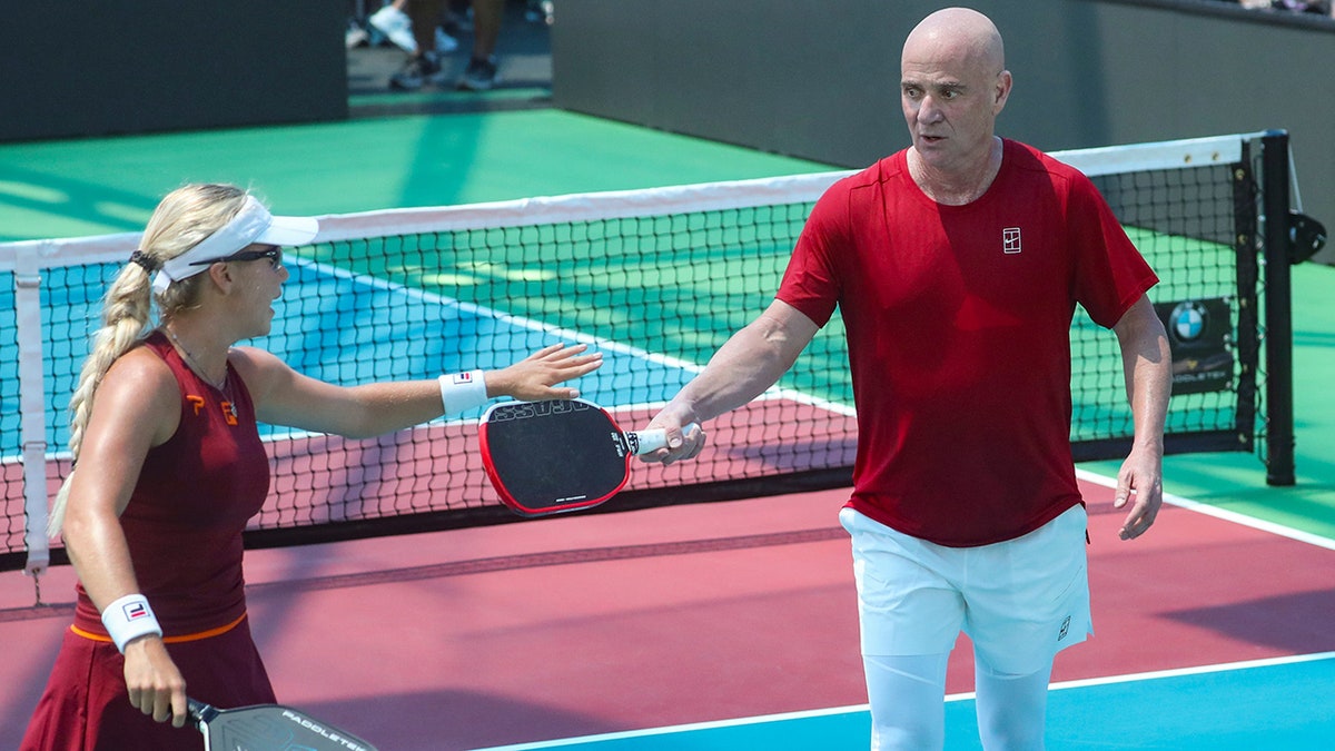 Andre Agassi and Anna Leigh Waters celebrate during game 1 of a Minto U.S. Open Pickleball Championships mixed pro doubles match in Naples, Fla., on April 30, 2025.