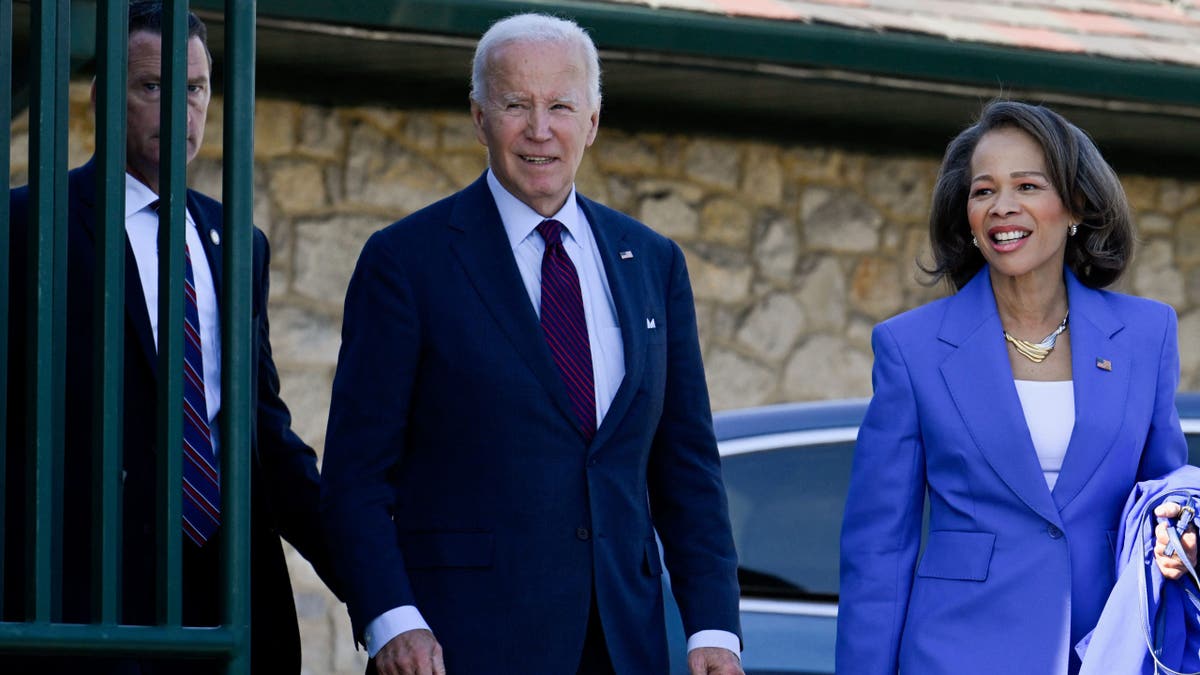 Former President Joe Biden, left, Sen. Lisa Blunt Rochester, D-DE, right
