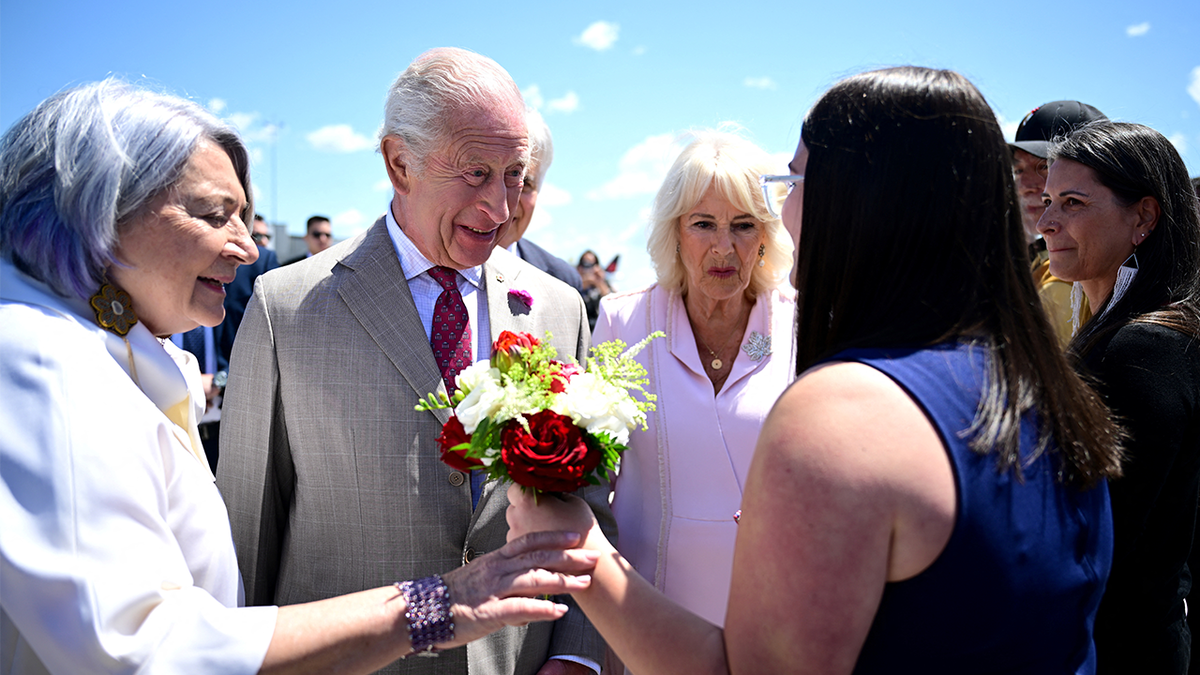 King Charles III and Queen Camilla are greeted
