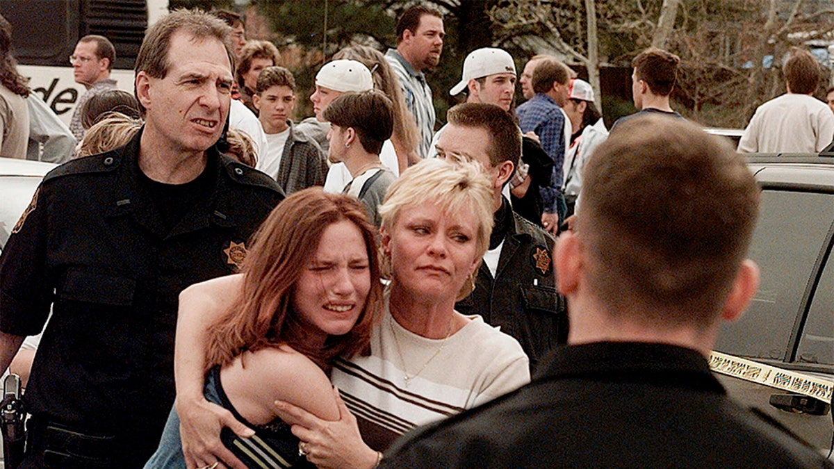 A woman embraces her daughter after they were reunited following the Columbine High School shooting