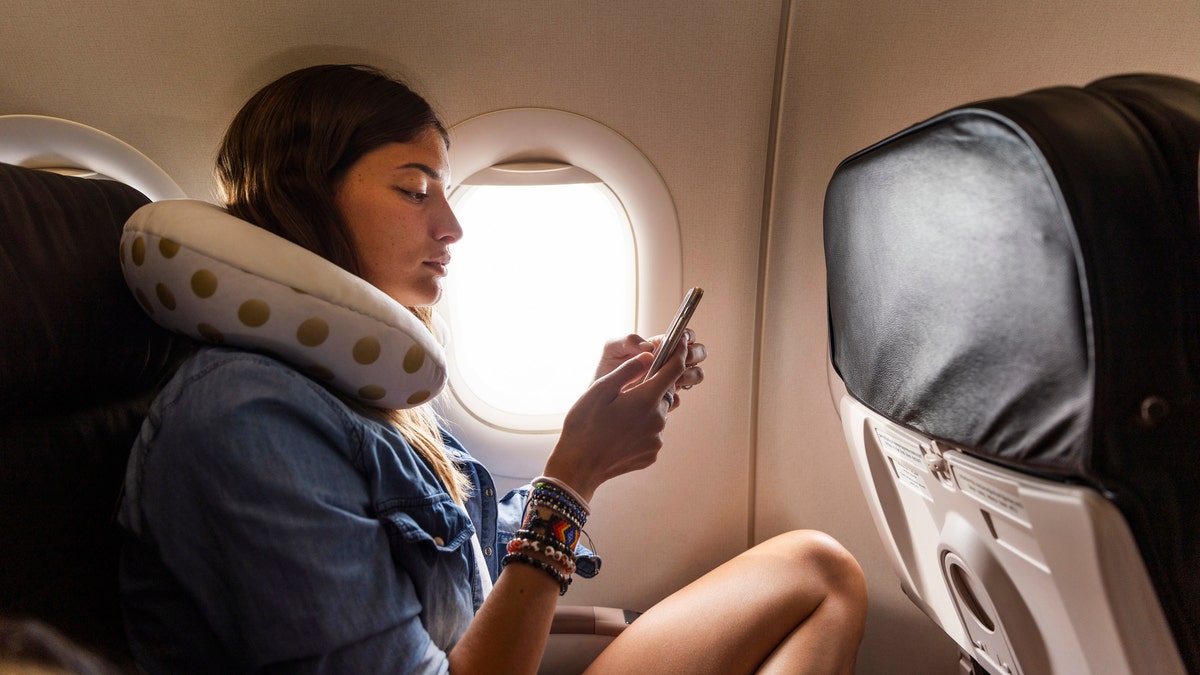 flight passenger with neck pillow