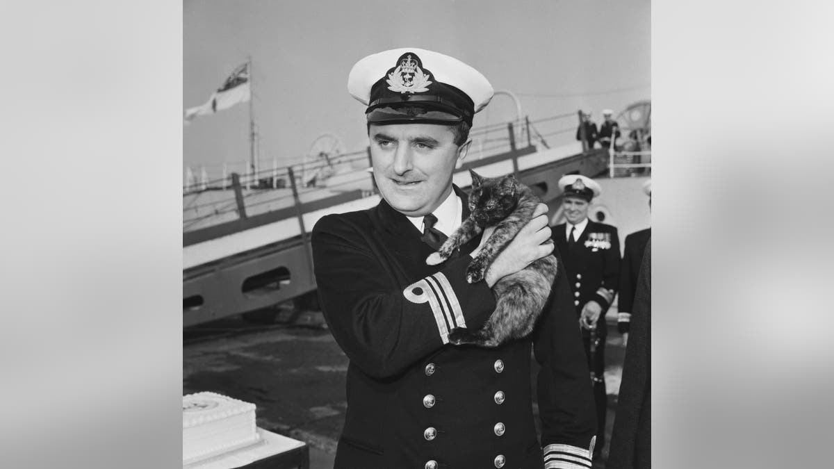 Captain holding cat