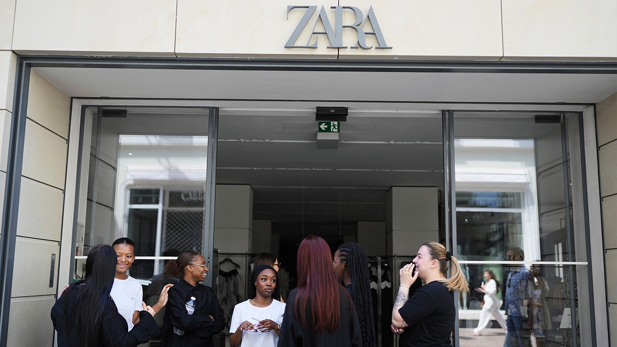 Employees standing in the doorway of a Zara store