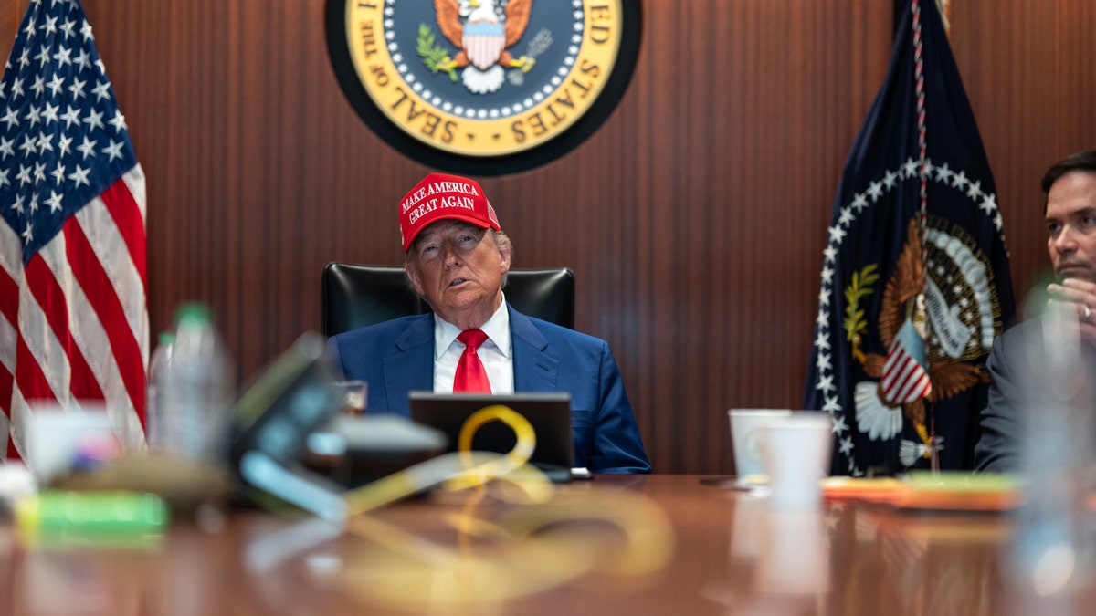 President Donald Trump wearing a MAGA hat in Situation Room