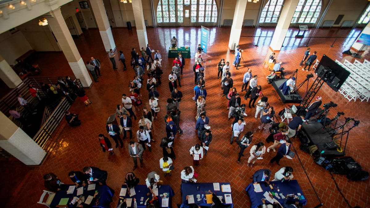 People wait in line to attend a naturalization ceremony at Ellis Island in New York, U.S., September 17, 2022.