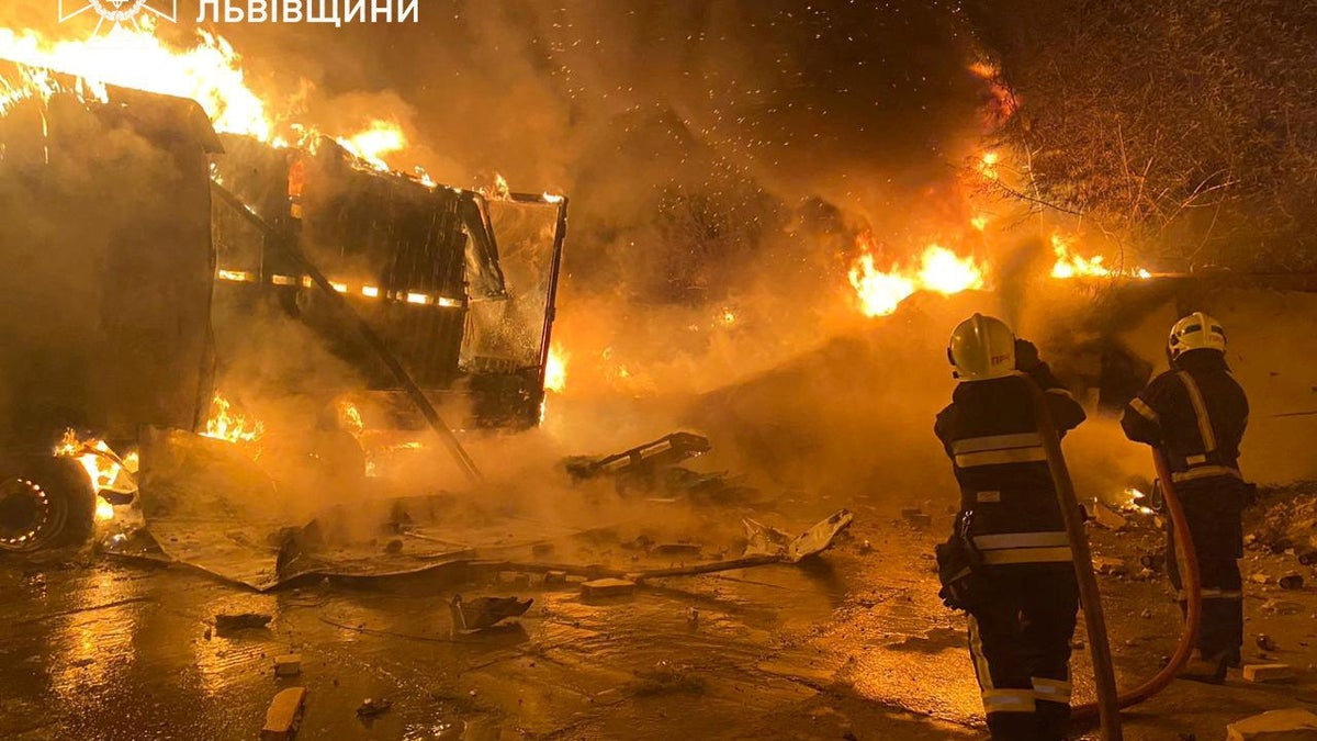 Firefighters extinguish fire in trucks at a site where warehouse facilities were hit during a Russian drone strike, amid Russia's attack on Ukraine, in the village of Murovane, outside of Lviv, Ukraine September 6, 2024,