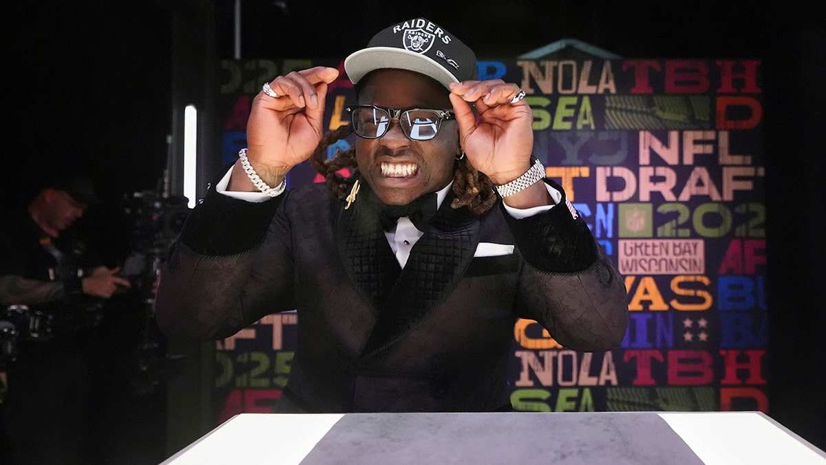 Ashton Jeanty puts on hat