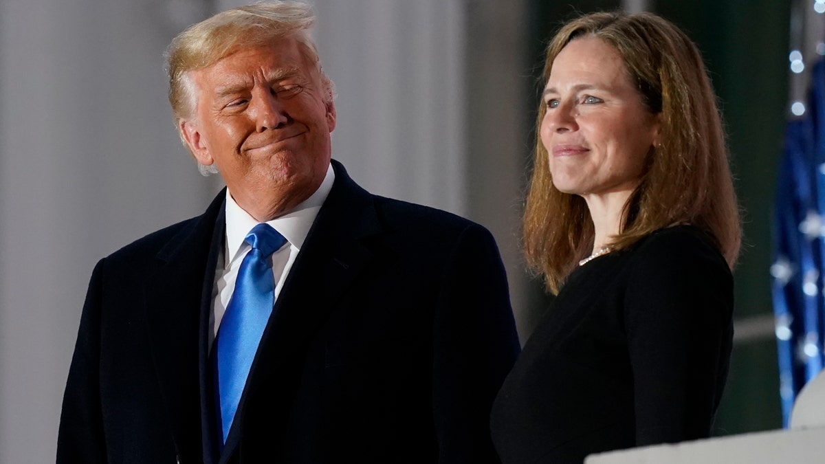 Trump smiling at Amy Coney Barrett